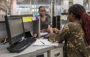 DC Credit union staff member helping member at a teller window