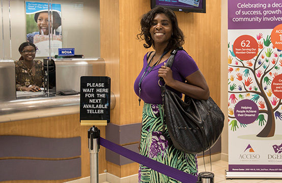 Woman smiling and standing in line at a bank